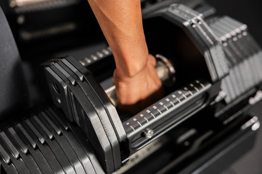 Athlete grabs onto the REP® x PÉPIN™ FAST Series™ Adjustable Dumbbell.