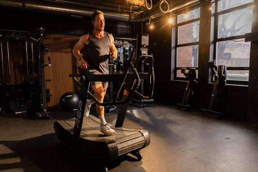 Athlete runs on the Strive™ Curved Treadmill.