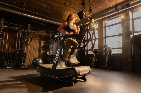 Athlete runs on the Strive™ Curved Treadmill.
