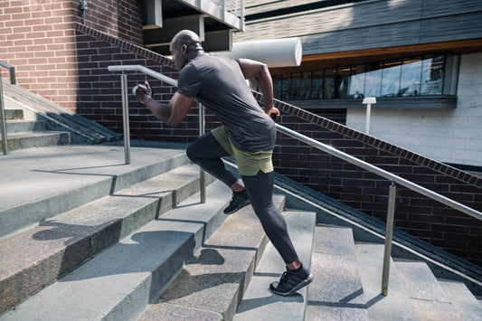 Athlete sprints up stairs in REP apparel.
