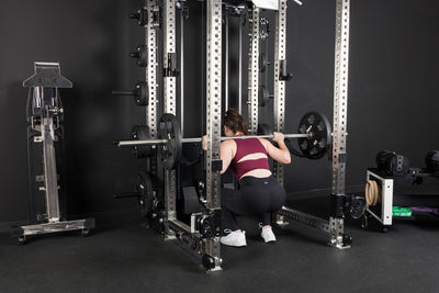 An athlete squatting inside the PR-5000 rack with Equalizer™ Urethane-Coated Plates