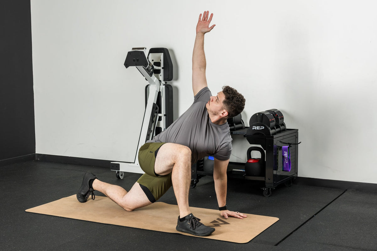 An athlete stretching on the REP premium cork yoga mat