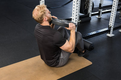 Athlete using the Leg Roller 2.0 for situps