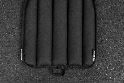 Black soft weight vest plate on a textured black surface