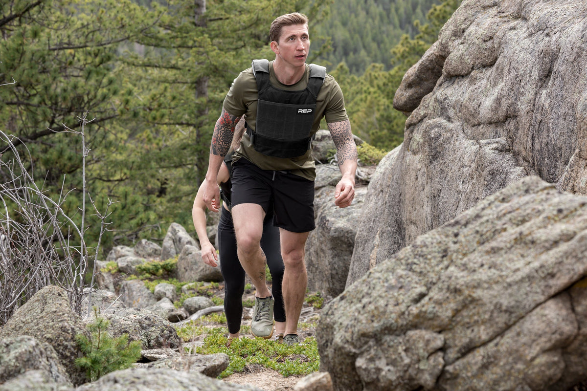 Athlete hiking in the with the Black Strata Weight Vest