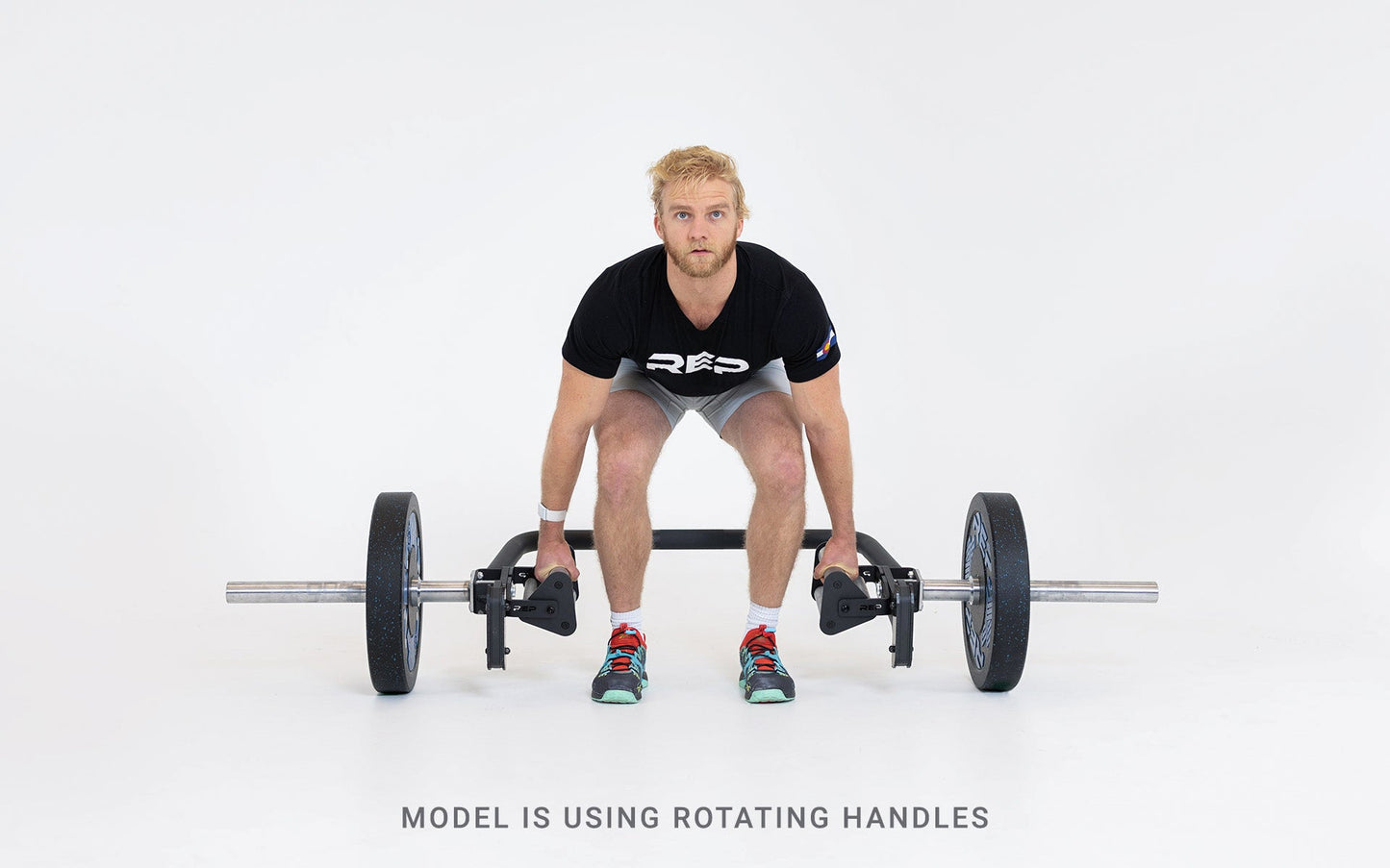 Lifter set up for a deadlift using the open trap bar with rotating handles.