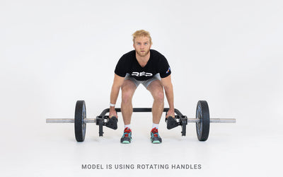 Lifter set up for a deadlift using the open trap bar with rotating handles.
